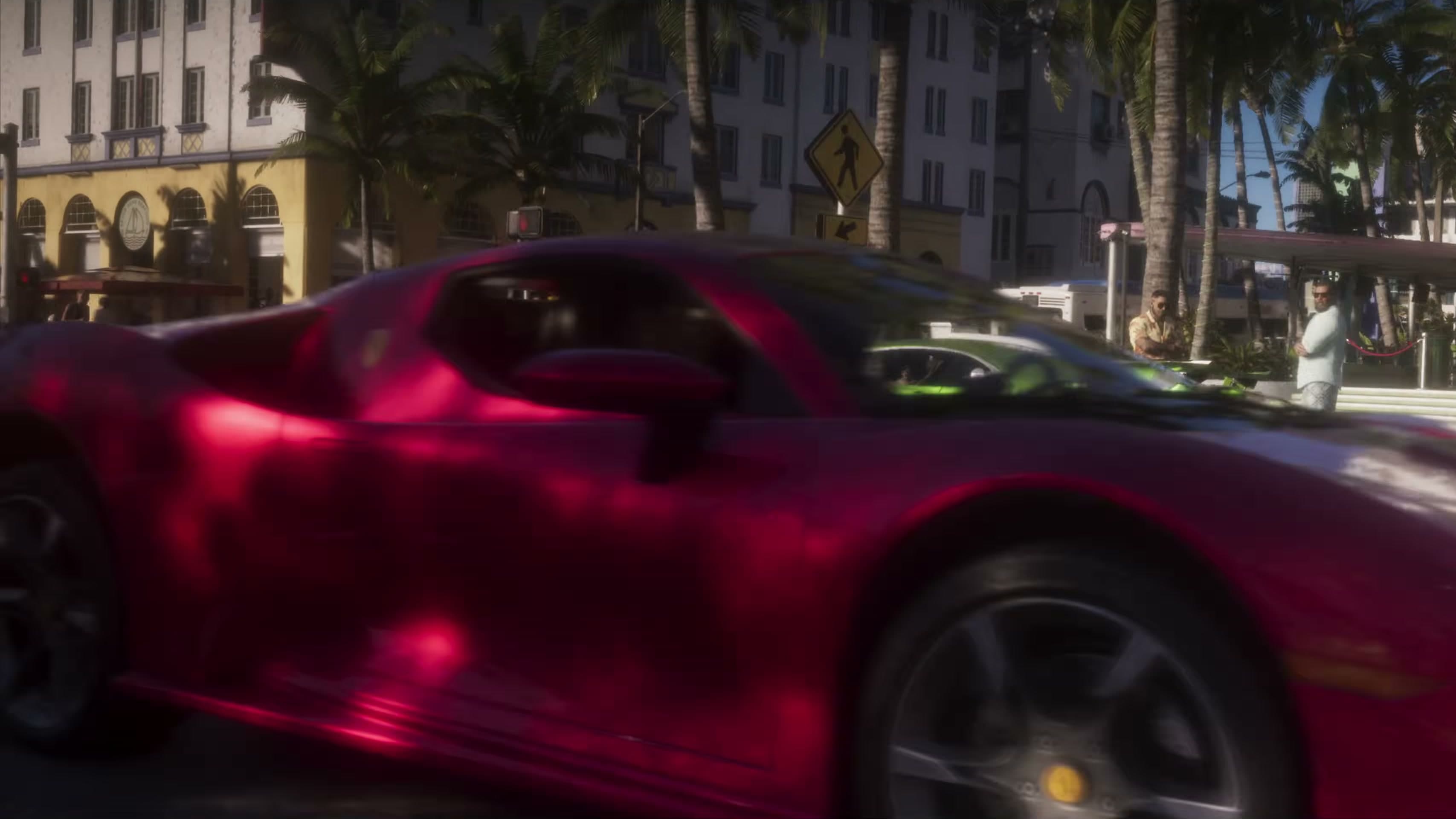 Red mid-engine sports car in the foreground on Shore Drive, with art deco buildings behind
