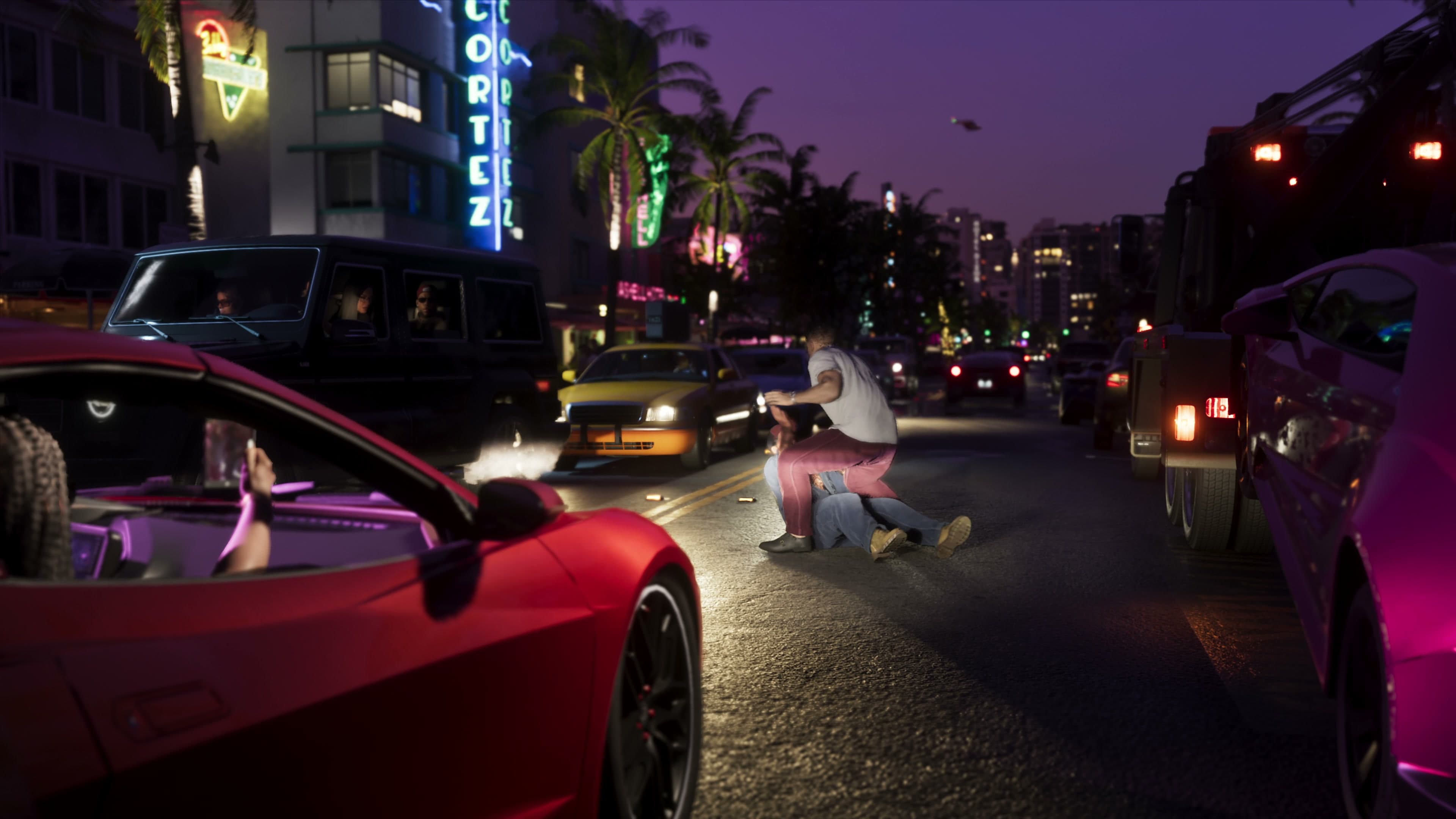 Fight in the middle of the road at night under the Cortez Hotel blue neon sign