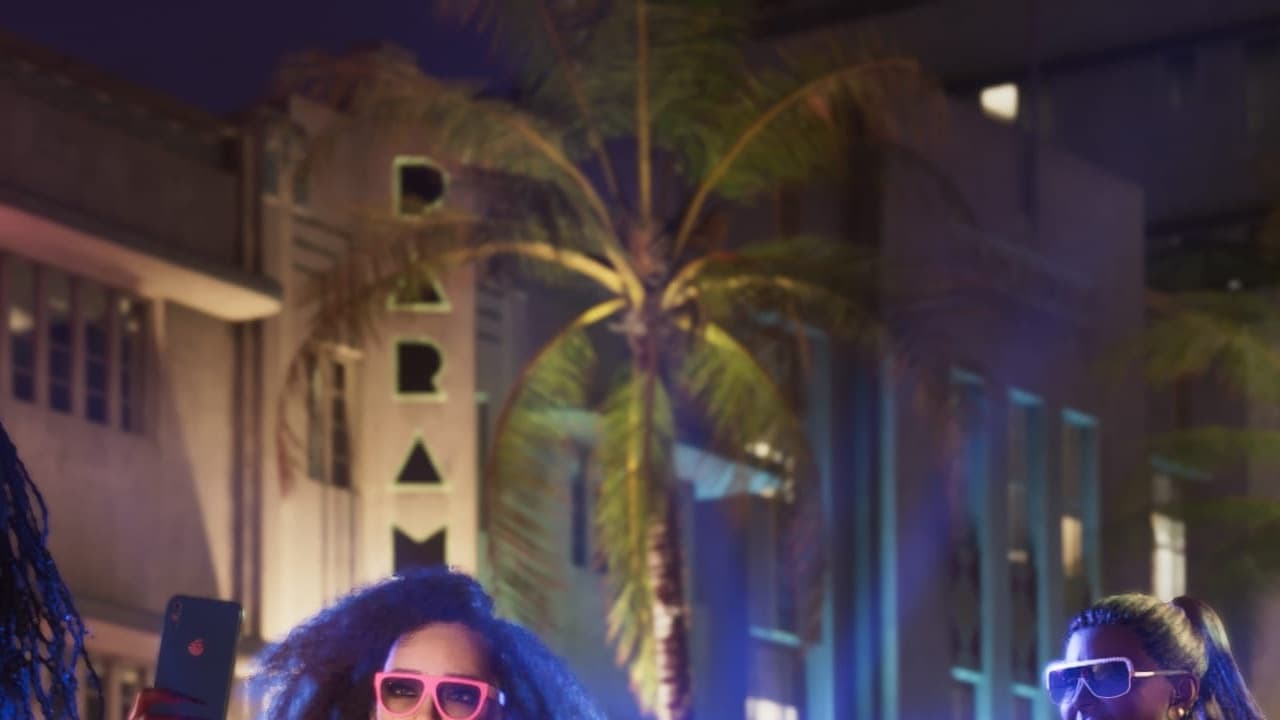 Paramour Hotel vertical neon between palms on Shore Drive at night