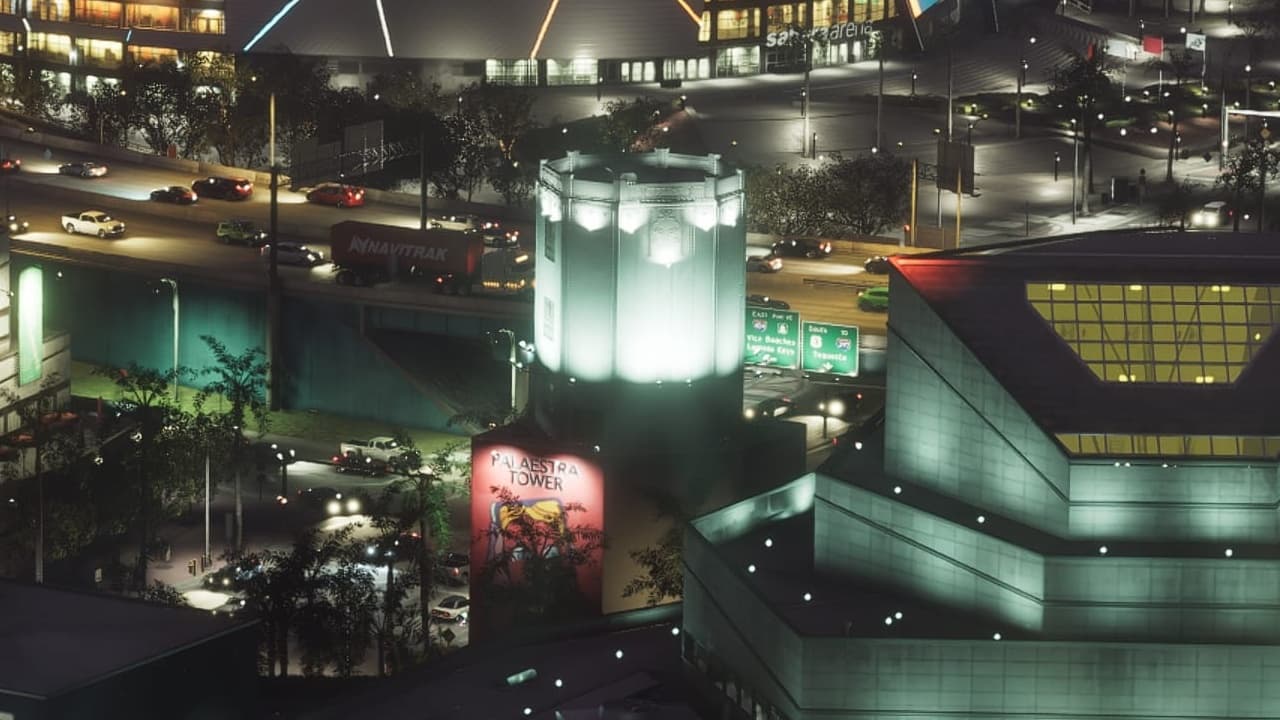 White art deco tower with a lit crown and its sign at the base