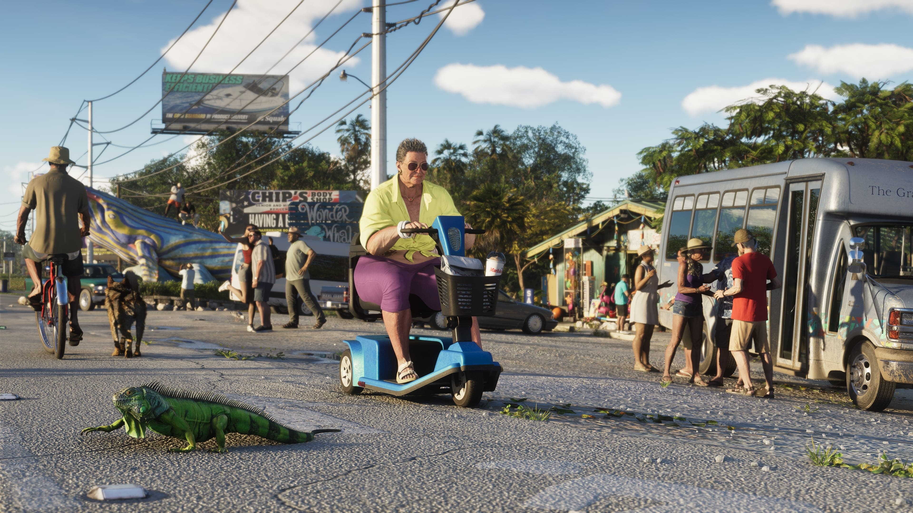Street in a coastal town with a man on a mobility scooter, people walking, a bus and an iguana crossing the road.