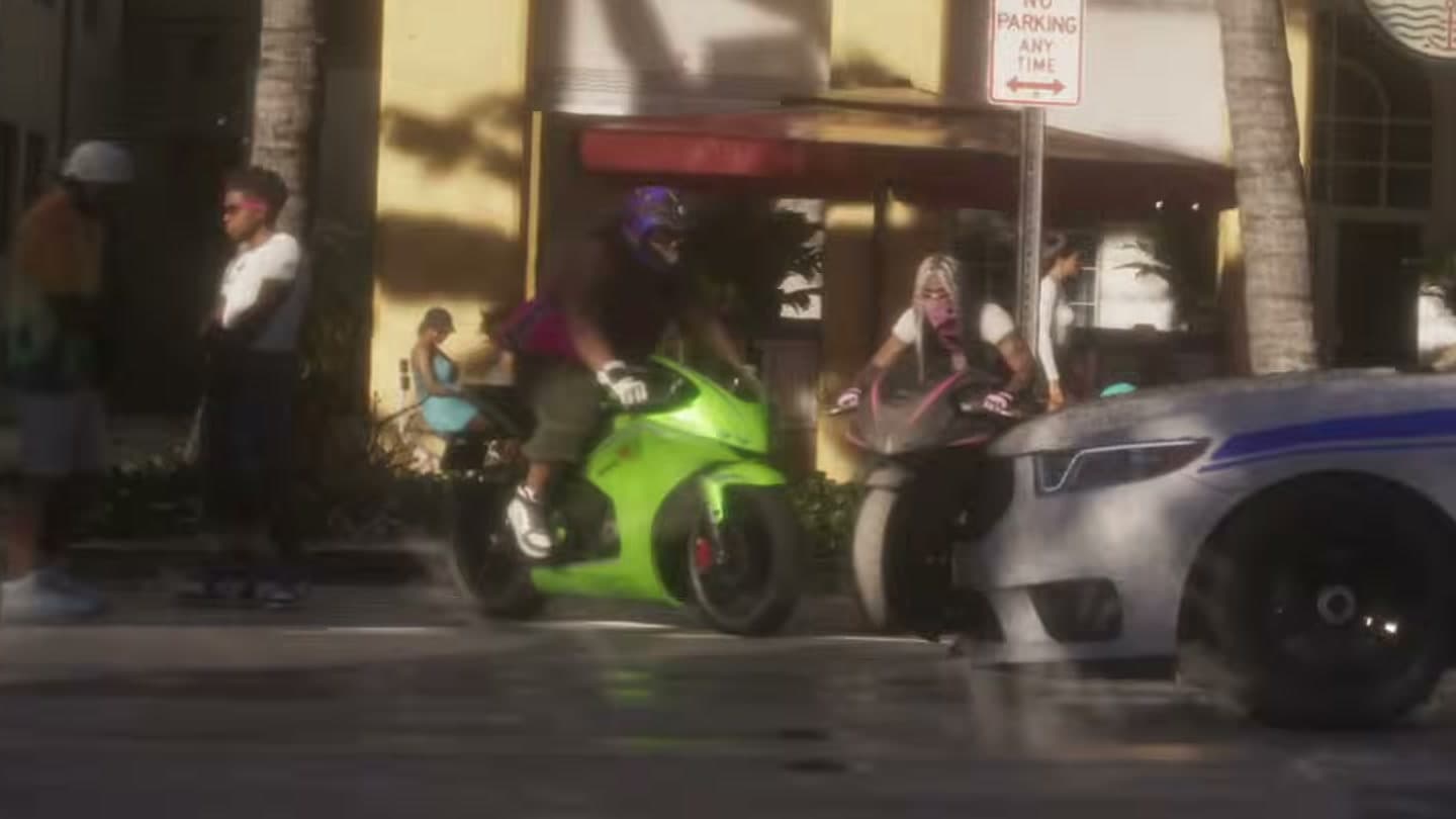 Two sport bikes, one green, by the curb as a patrol car passes
