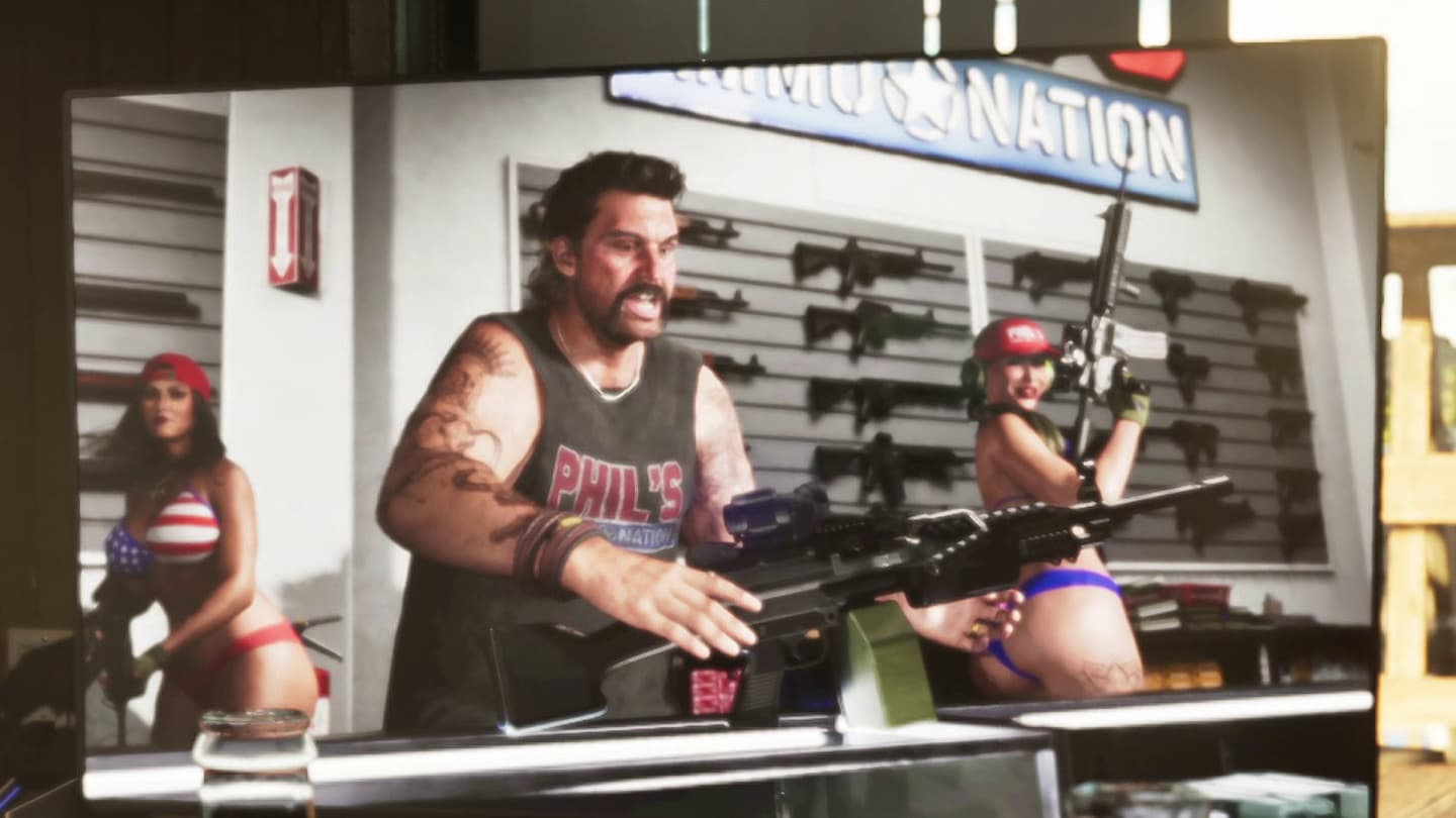Phil holding a machine gun in the Phil's Ammu-Nation TV ad