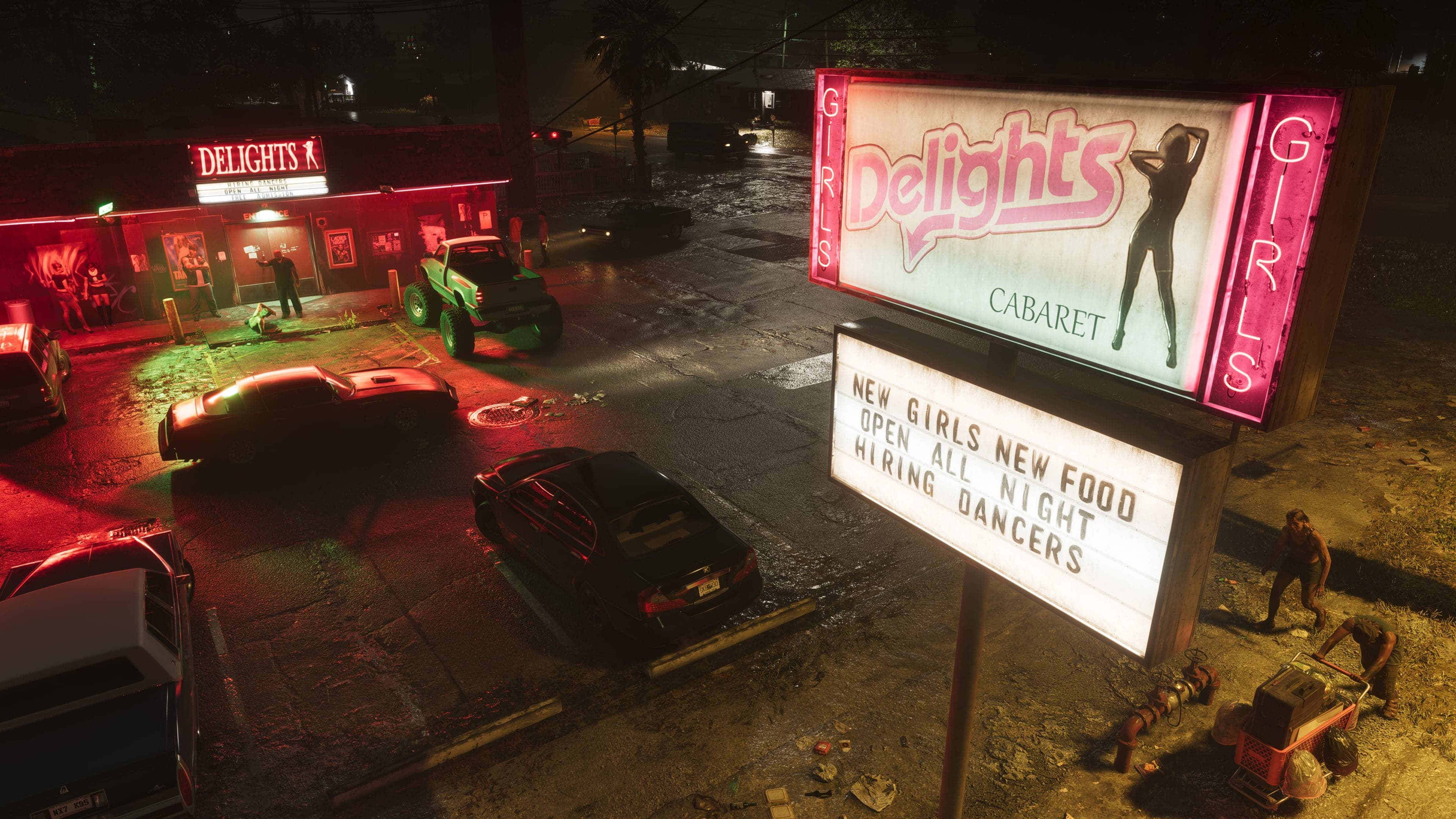 Nighttime parking lot of a club with the glowing Delights sign and a marquee board.