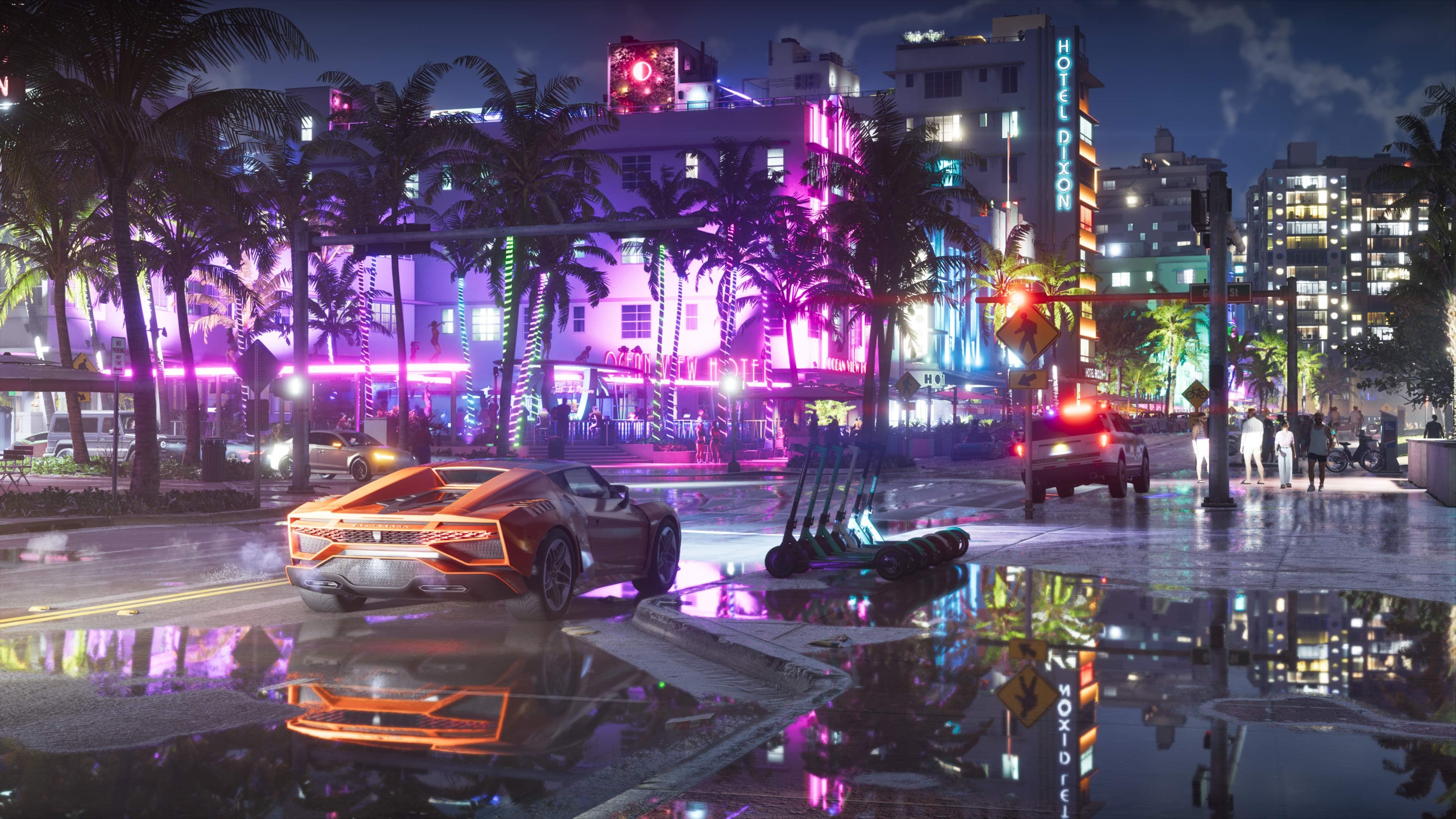 Neon front of the Ocean View Hotel in Vice City at night, with a wet street and an orange sports car