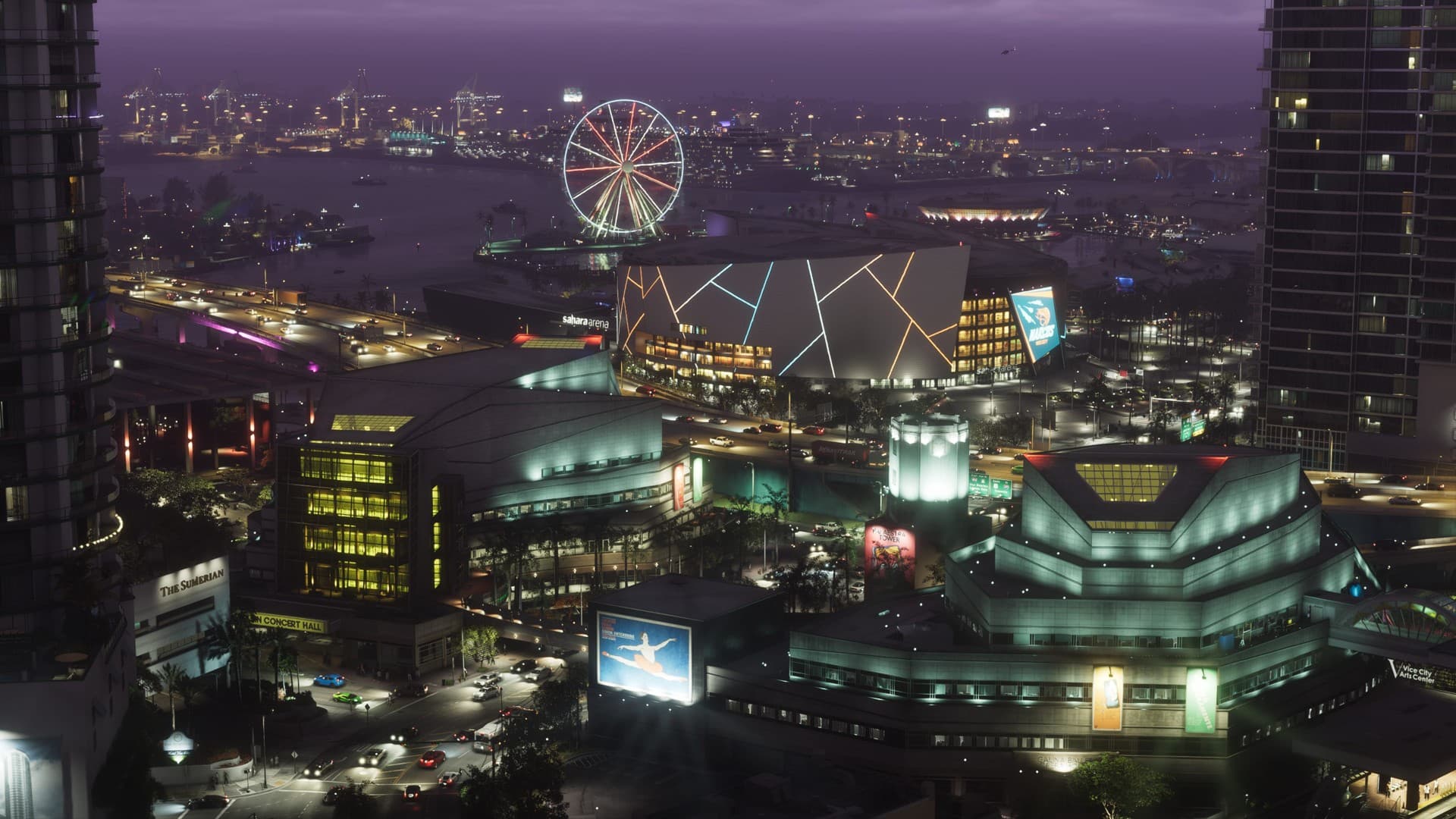 Vista nocturna de Vice City iluminada, con una noria, un estadio y rascacielos junto al agua.